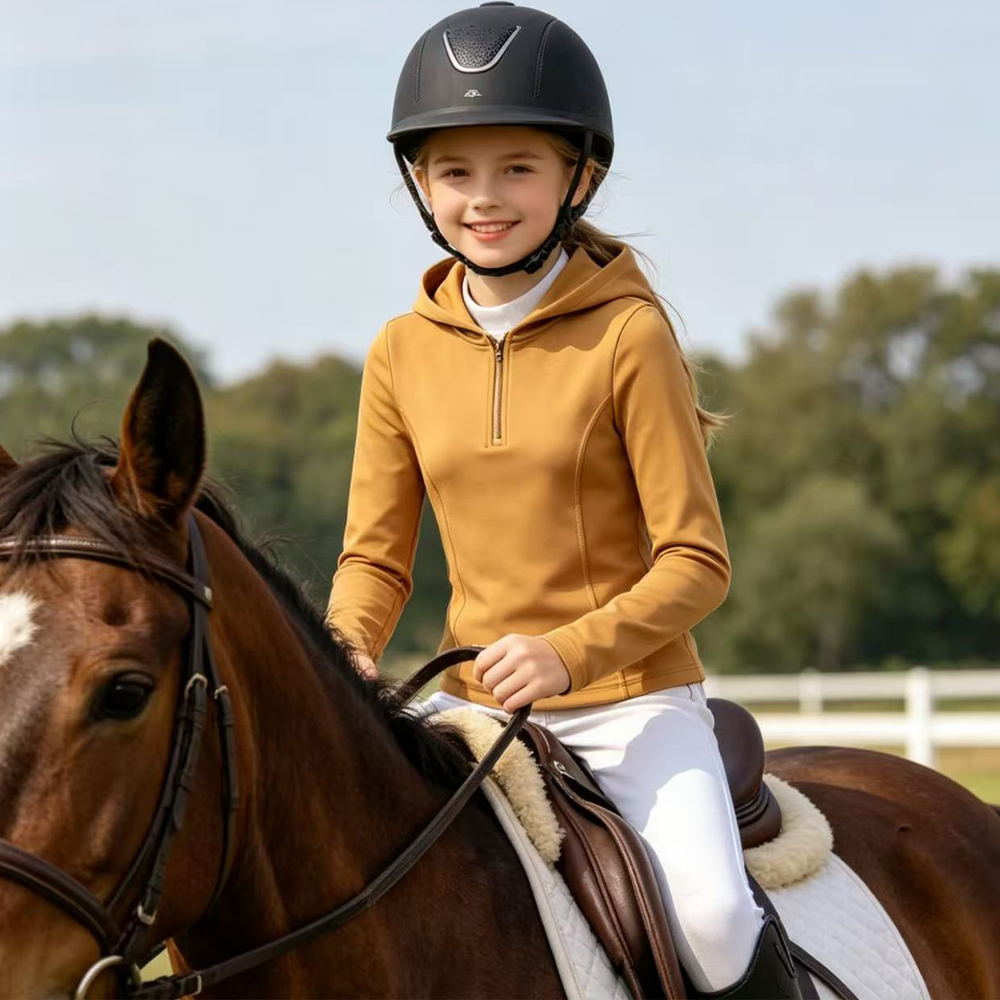Young rider wearing equestrian apparel with a horse